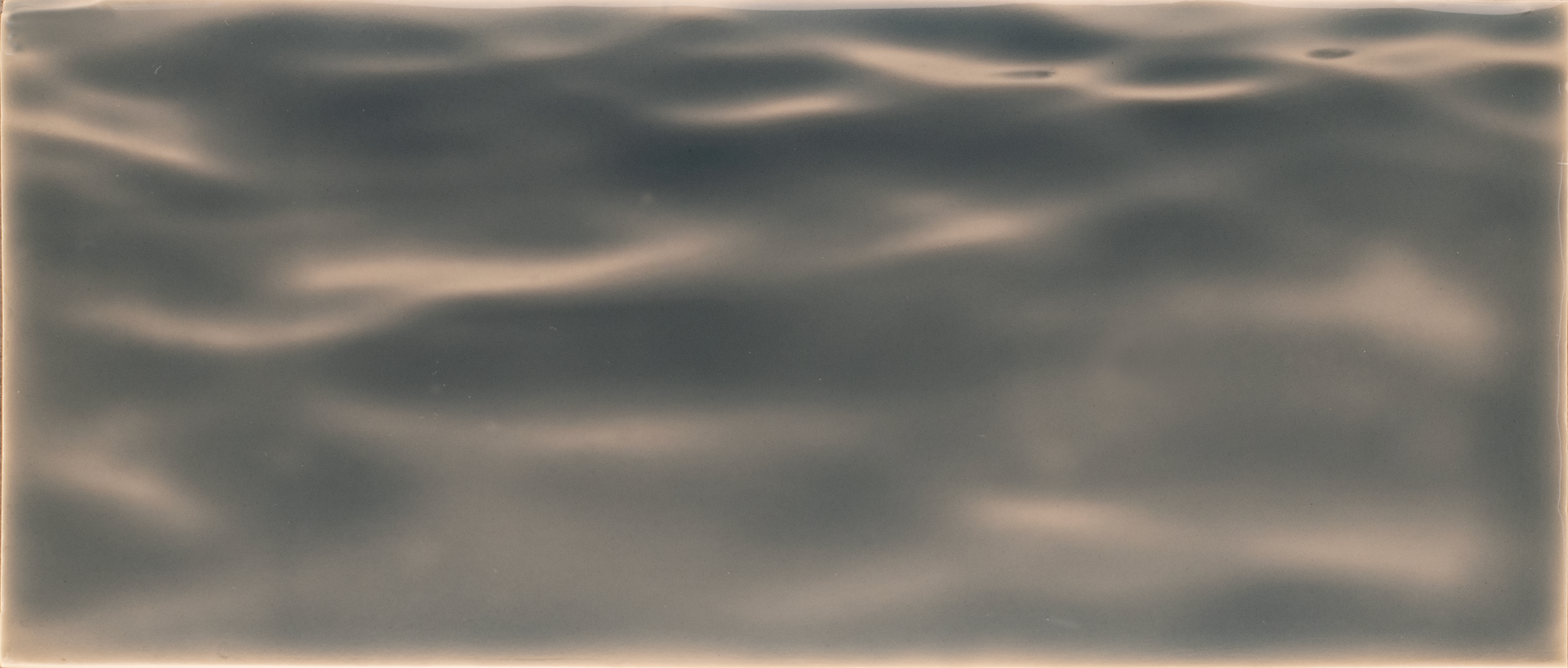 Textured tile mural in seaglass style, resembling water surface, ideal for enhancing shower wall aesthetics.