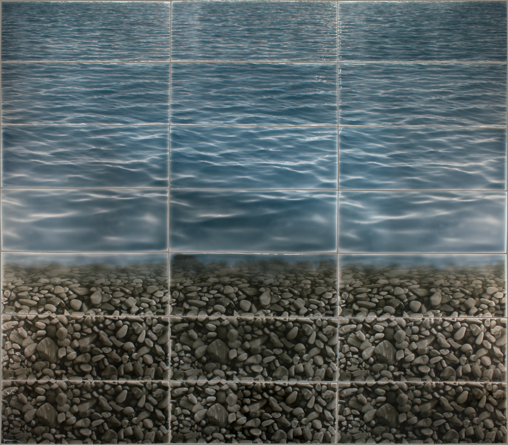 Tile mural featuring a realistic design of a serene water surface above a textured pebble shoreline, ideal for enhancing shower wall aesthetics.