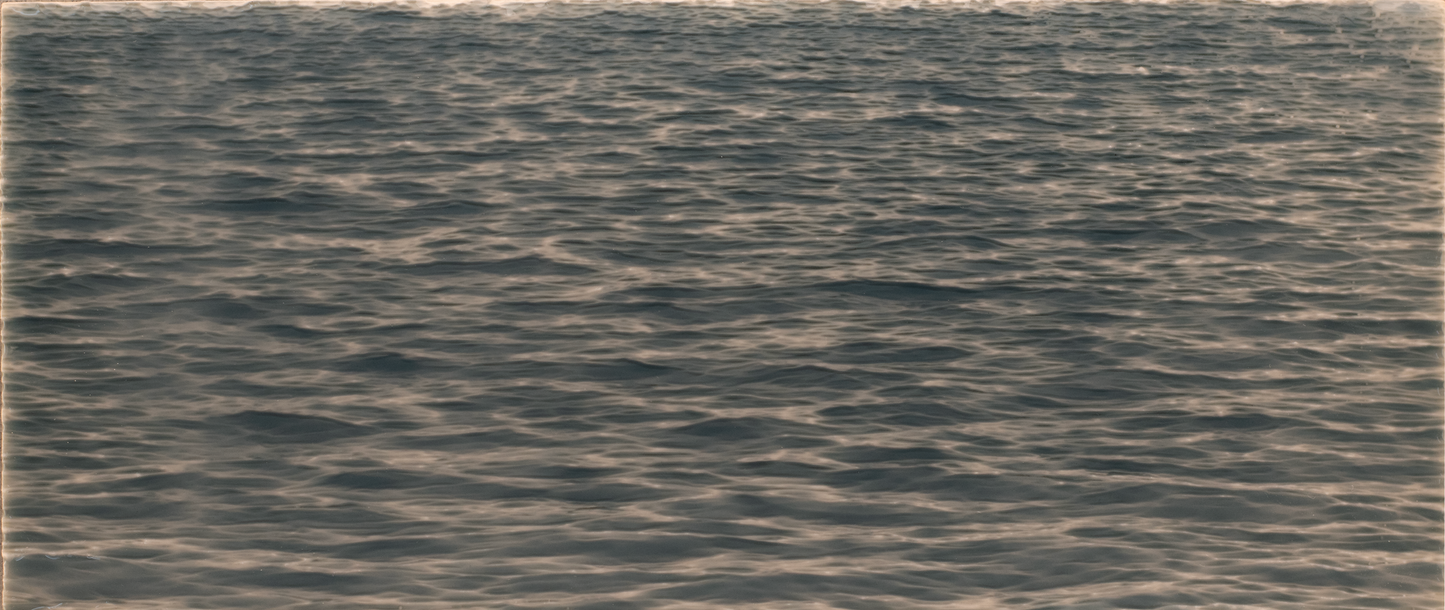 Ocean water surface with gentle ripples, reflecting light, ideal for shower wall tile mural design.