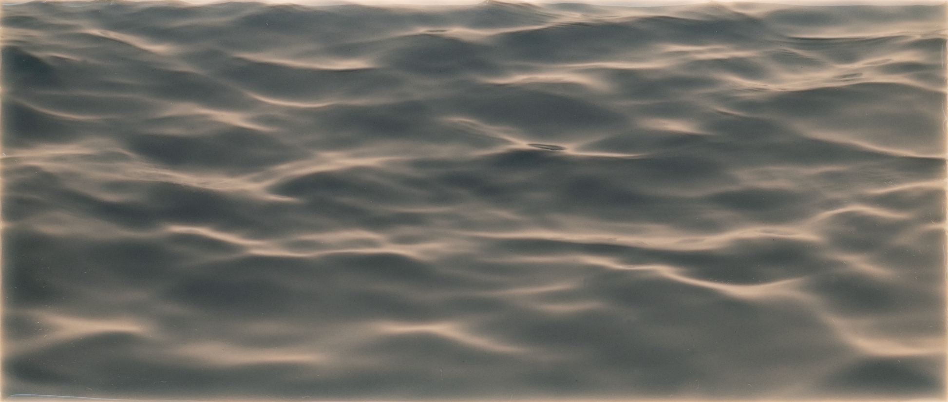 Textured tile mural design resembling gentle water waves, ideal for enhancing shower wall aesthetics with a calming ambiance.