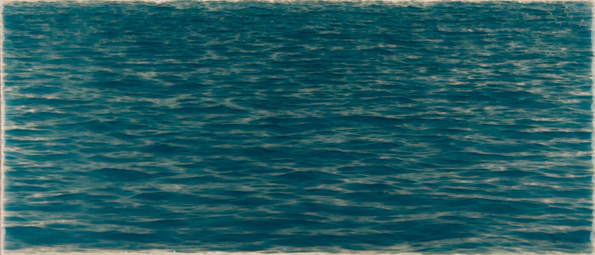 Beach-themed bathroom tile mural featuring tranquil blue ocean water with gentle waves, enhancing coastal decor.