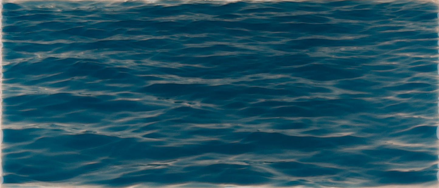 Deep blue water surface with gentle ripples, evoking a beach-themed atmosphere for bathroom decor.