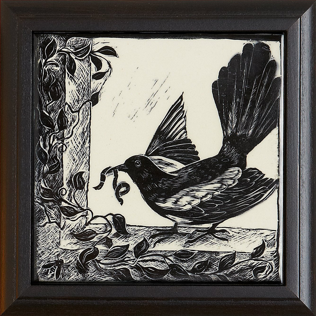 Black and white woodcut tile featuring a bird with a curled vine in its beak, framed by decorative leaves, part of Living Walls Tile's art collection.
