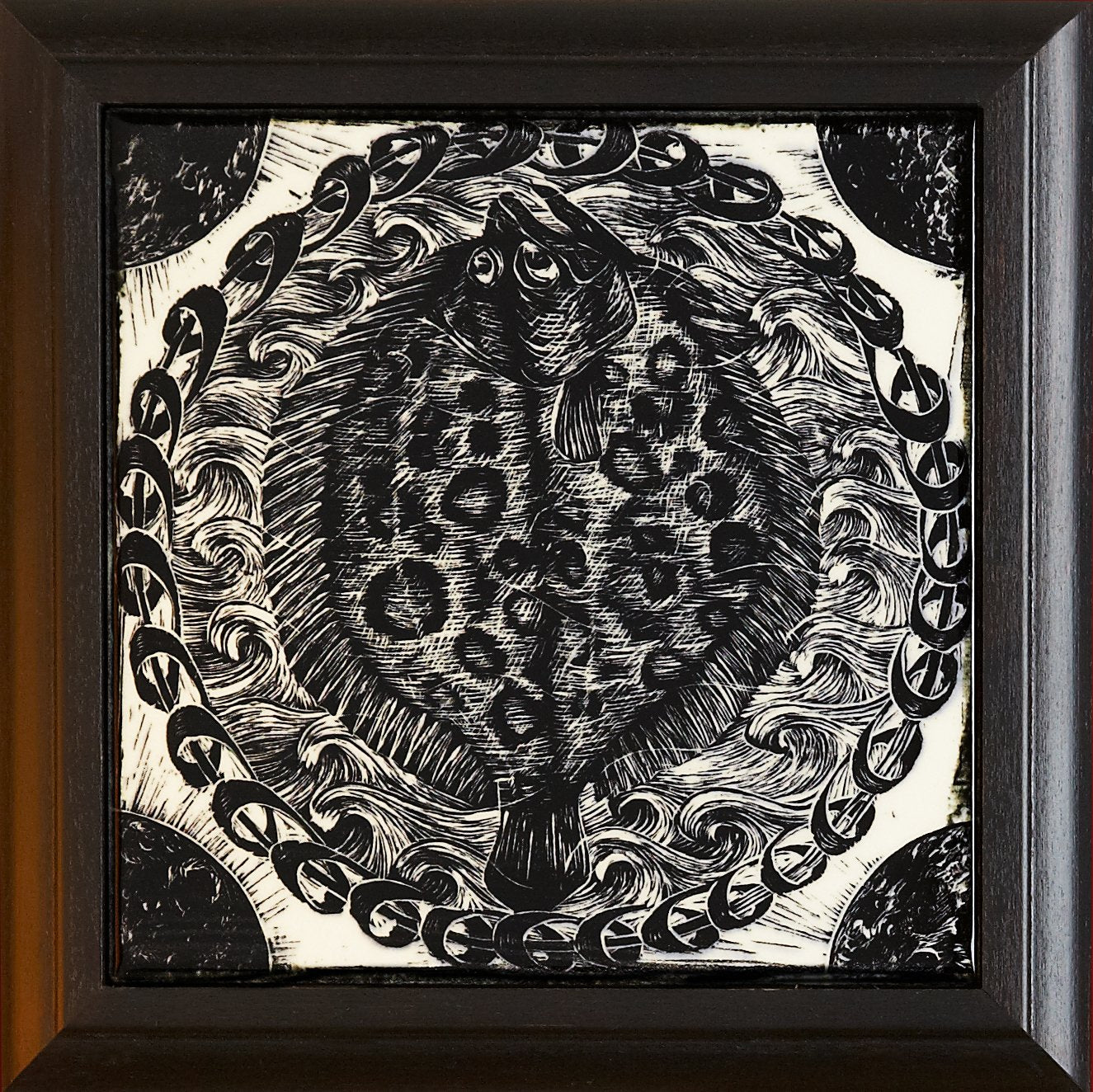 Framed black and white woodcut tile featuring a stylized fish design surrounded by swirling waves and decorative elements, part of Living Walls Tile's Black and White Woodcut Series by David Regan.