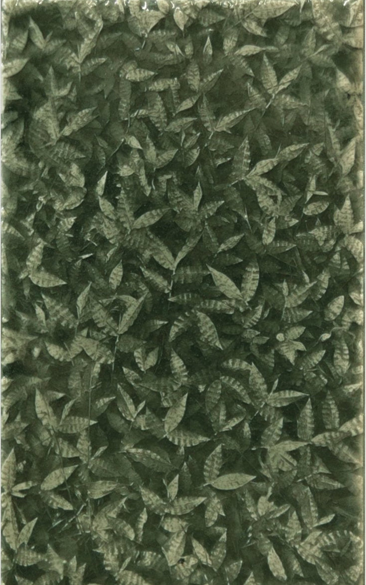 Leaf-patterned decorative tile featuring a dense arrangement of green foliage, inspired by tropical forests, ideal for enhancing home interiors with natural elegance.