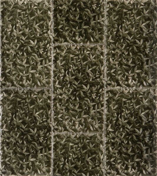 Leaf-patterned decorative tiles in earthy green tones, inspired by tropical foliage, showcasing natural elegance for home interiors.