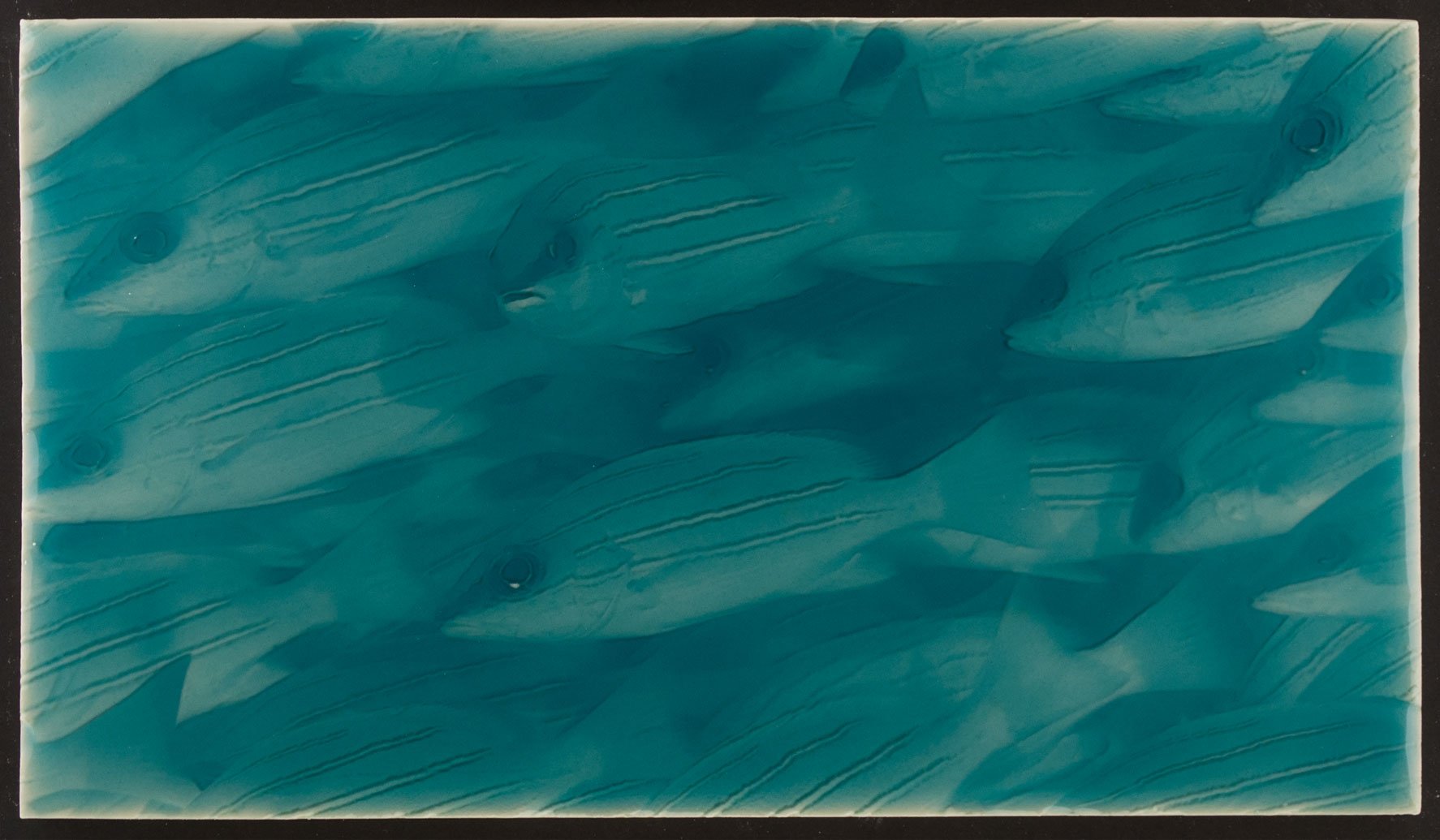 Artisan tile featuring a design of little fish in a turquoise ocean-inspired background, ideal for coastal bathroom decor.