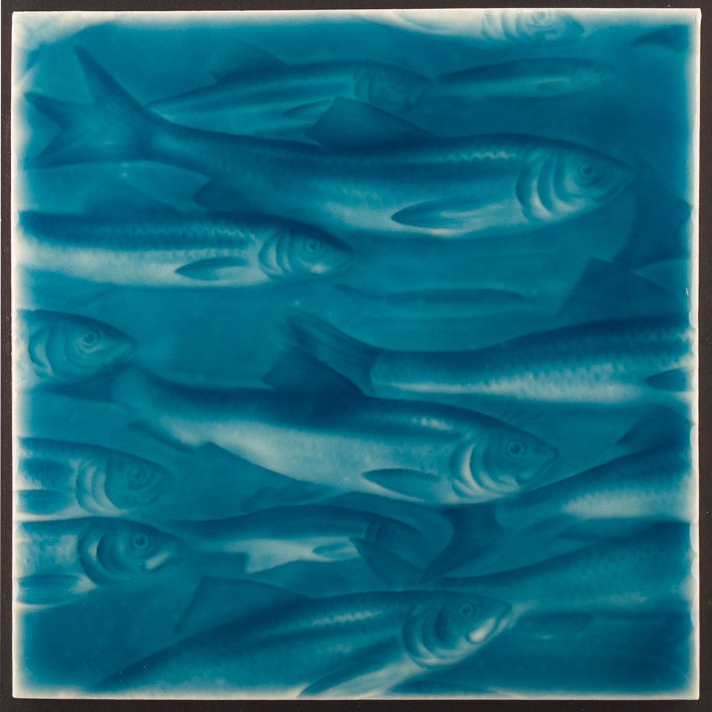 Blue beach-themed wall tile featuring embossed fish design, ideal for coastal-inspired home decoration.