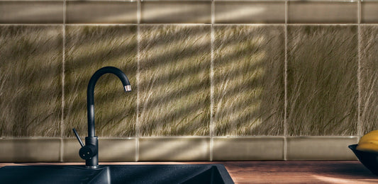 Modern farmhouse kitchen backsplash featuring nature-inspired native grasses tile, black faucet, and dark sink, enhancing home interior aesthetics.