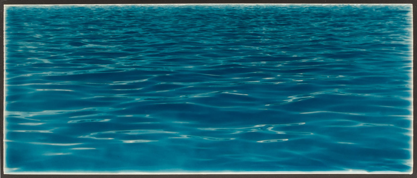 Ocean water tile mural with tranquil blue waves, ideal for beach-themed bathroom backsplash design.