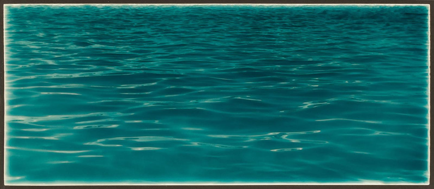 Tranquil ocean water surface with gentle ripples, ideal for beach-themed bathroom backsplash inspiration from Living Walls Tile.