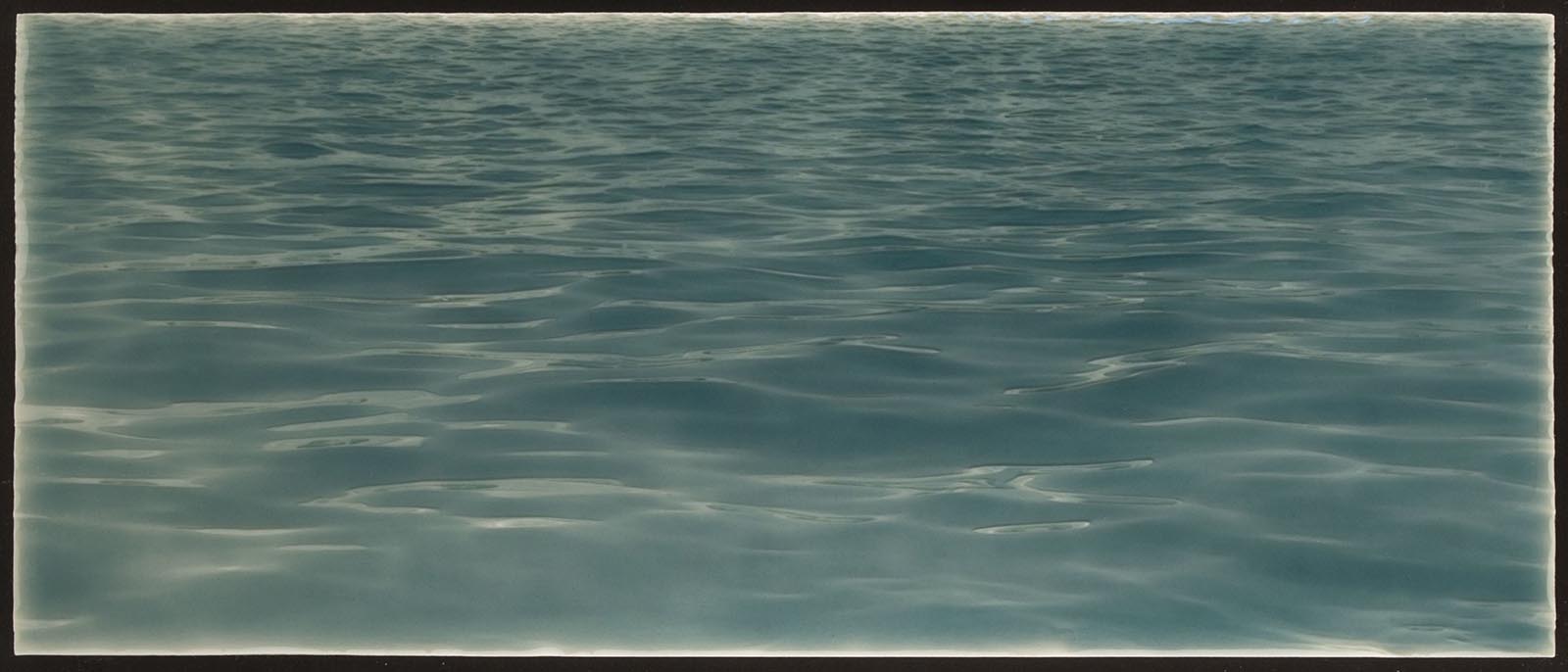 Tranquil ocean water backsplash tile design, featuring soothing blue hues and gentle wave patterns, ideal for beach-themed bathroom decor.